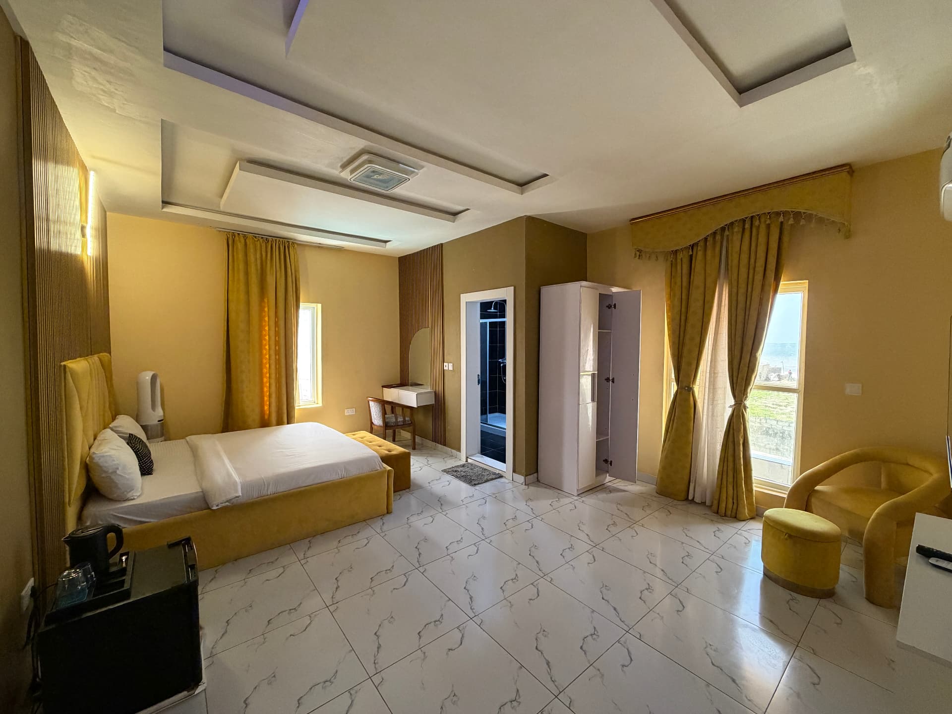 The room in gold, sea beyond the window - Luxury Room at Timeless Haven & Cottage, photo 1 of 2