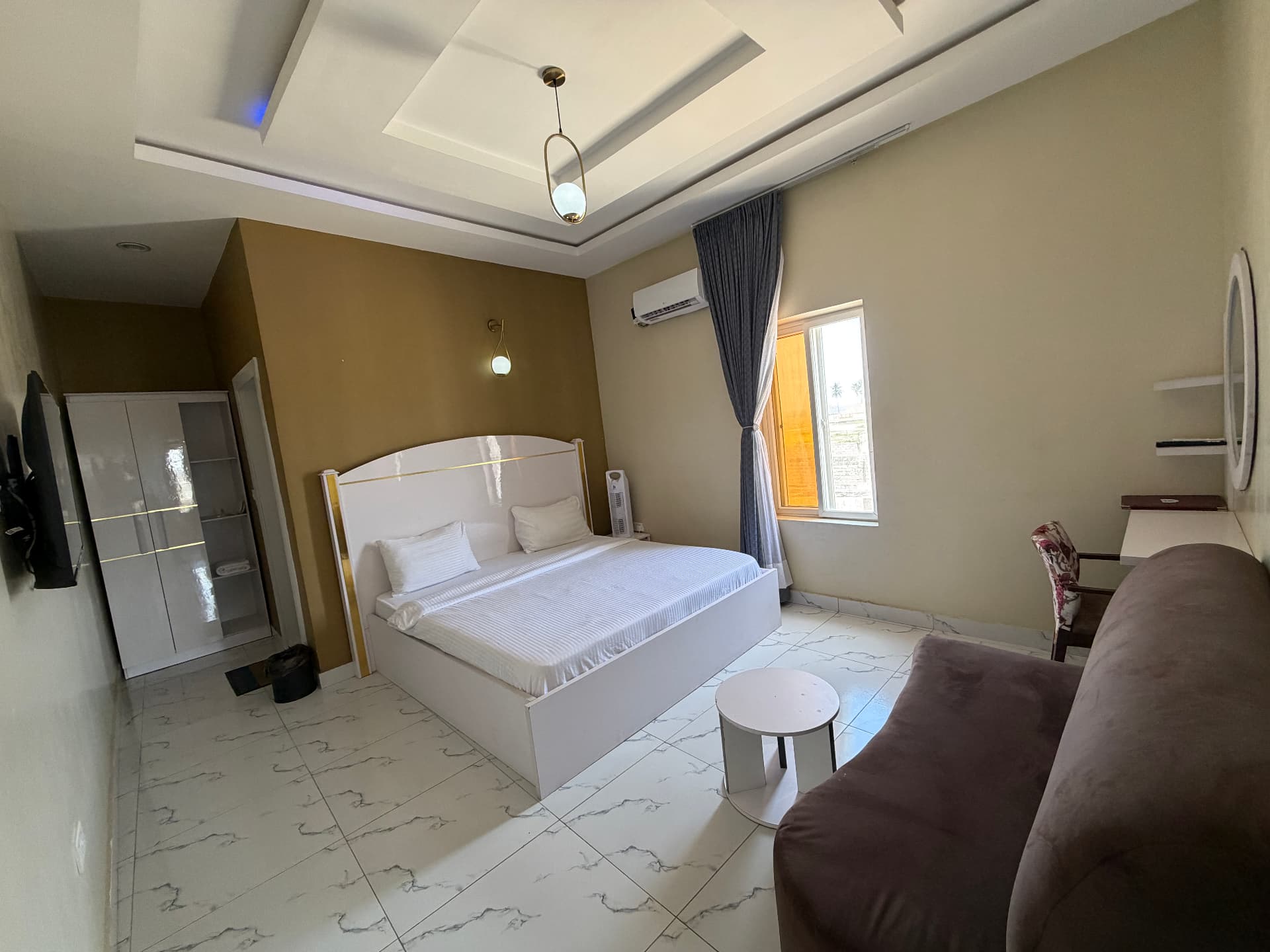 The queen bed and shuttered window - Mini Suite at Timeless Haven & Cottage, photo 1 of 1